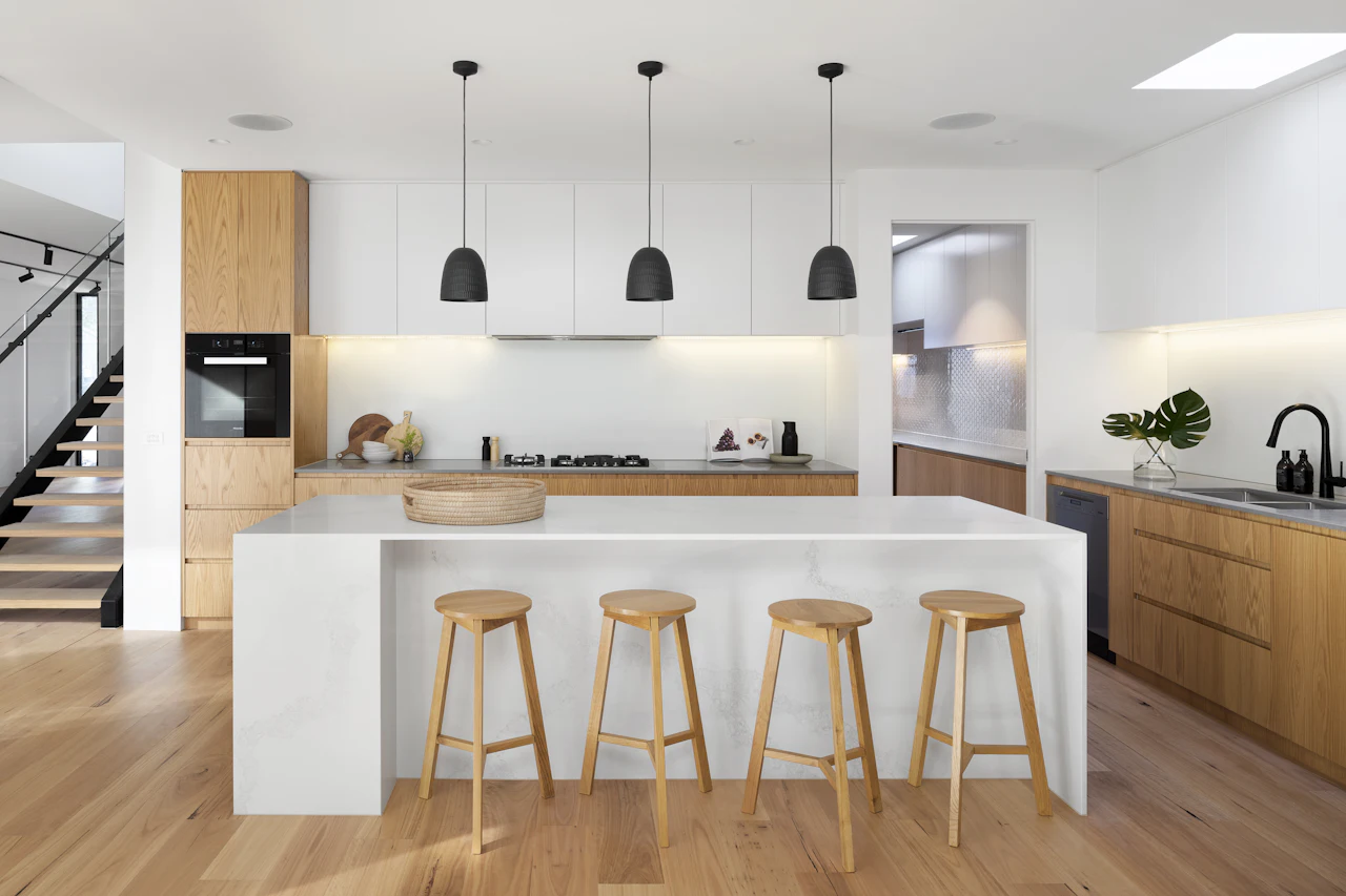 Kitchen with oak cabinetry and a white island