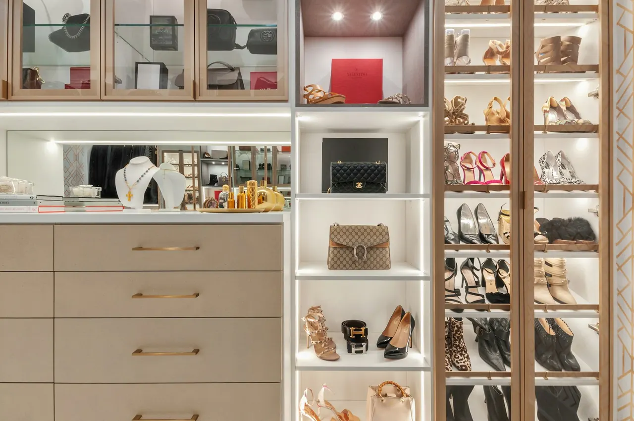 Closet with lit glass shelving for shoes and handbags