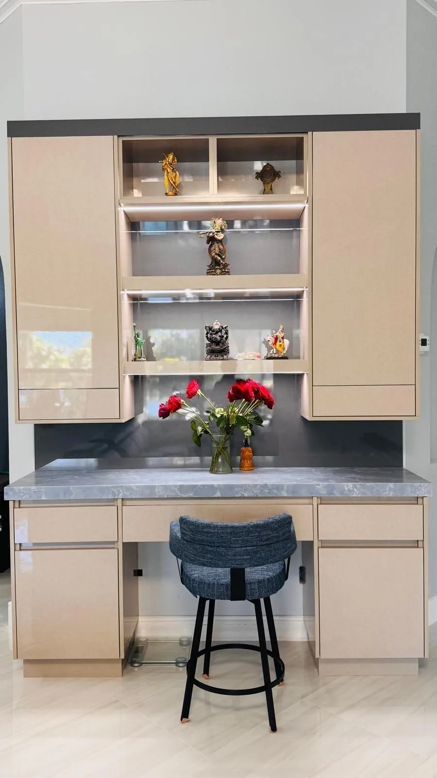 Built-in desk with lit display shelves and a blue stone top